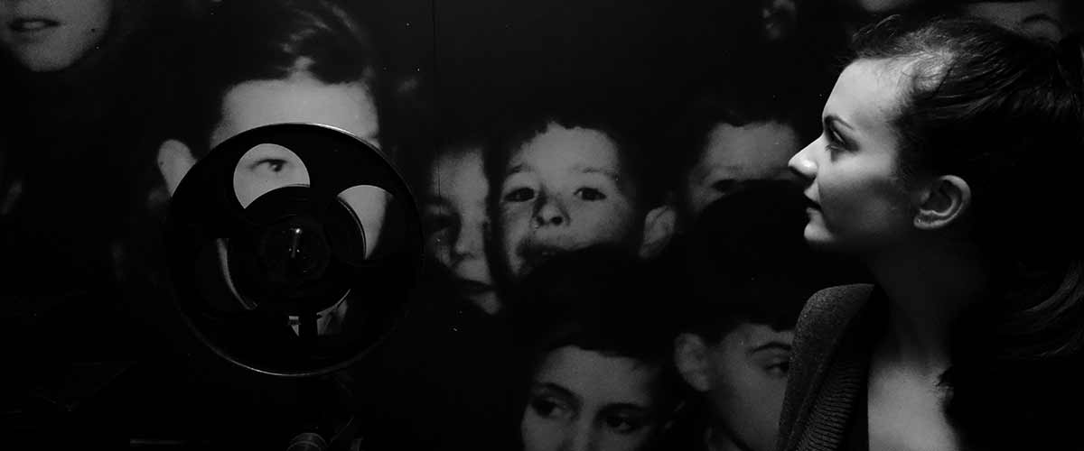 Film projector showing image of children in black and white